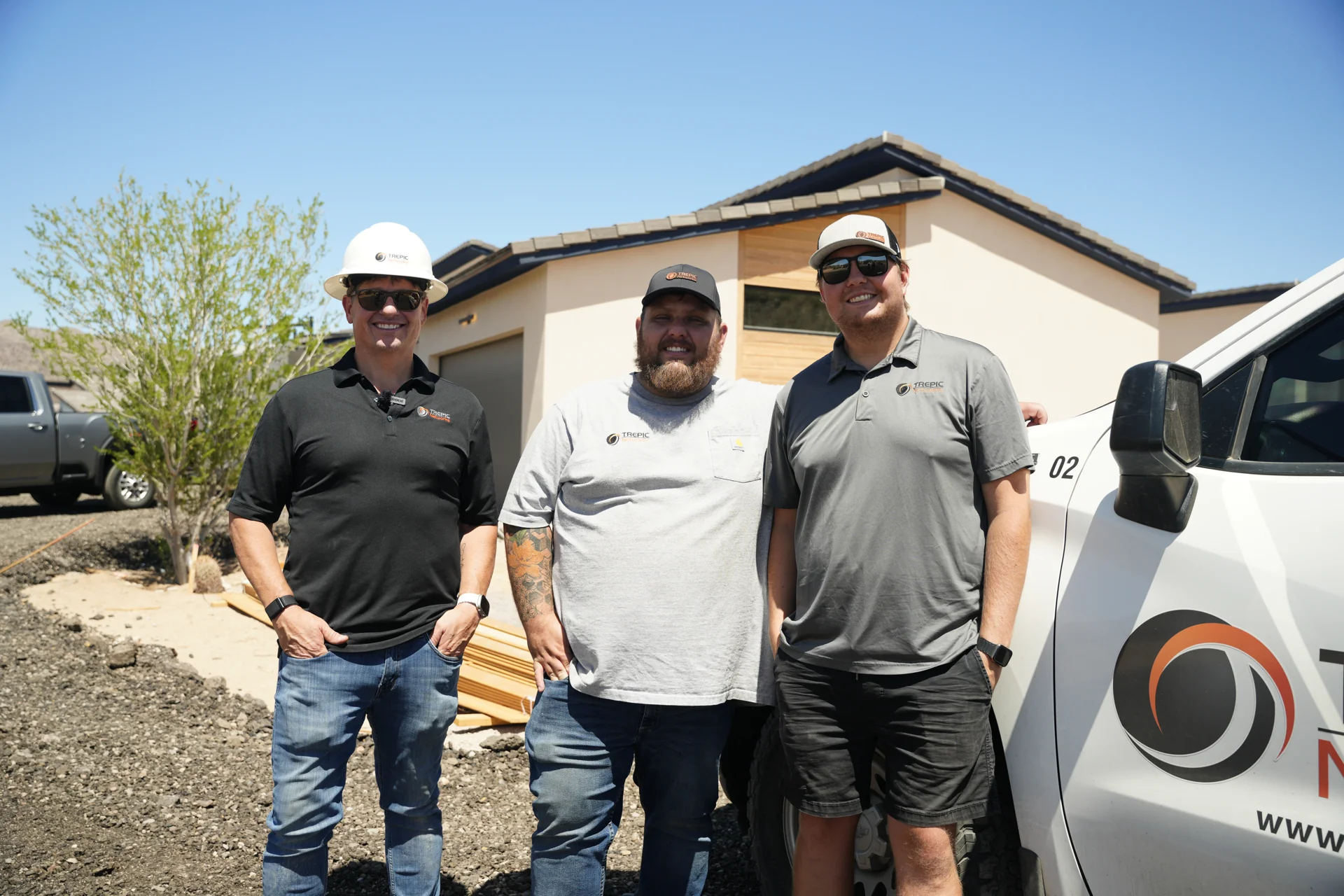 Three TREPIC team members on a local installation, beside their TREPIC service truck.